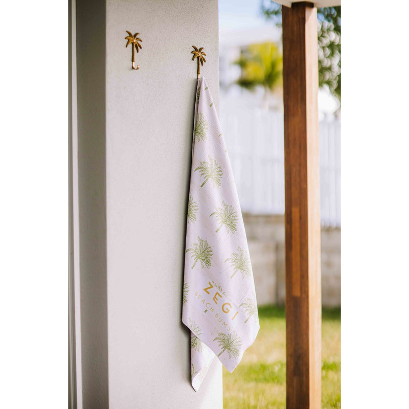 Moroccan Sand Free towel hanging by the pool on a brass palm hanging hook